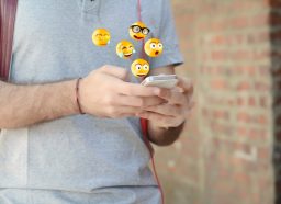 man texting emojis