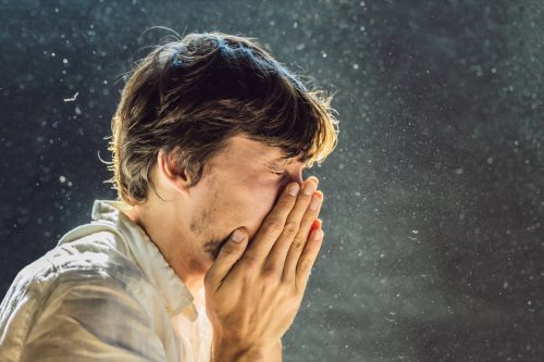 man sneezing and uncovering more weird facts about the human body