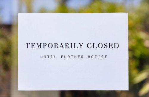 Close up shot of temporarily closed sign at entrance door, during Coronavirus outbreak