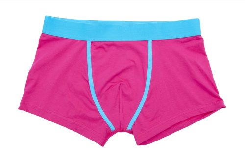 pair of pink boxer shorts in front of white background
