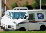 Line of United States Postal Service USPS delivery vehicles or vans in a parking lot. Corner of 9th street and 22nd avenue in downtown Meridian, MS.