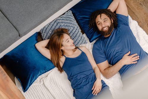 Woman and man in bed wearing matching blue Cool-jams pajamas