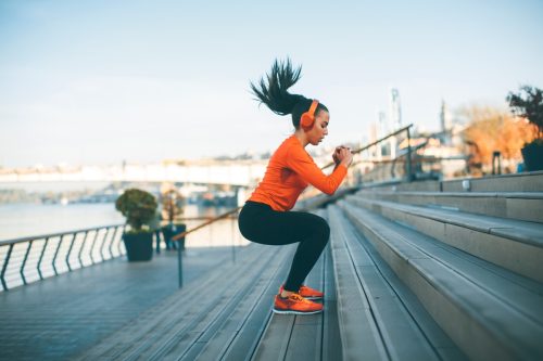woman jumping while she exercises outside