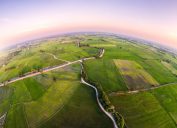 green rice paddies from above showing the curve of the earth - world facts