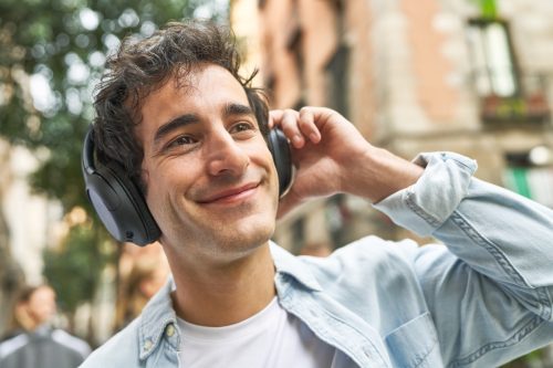 Happy Young Man with Headphones on