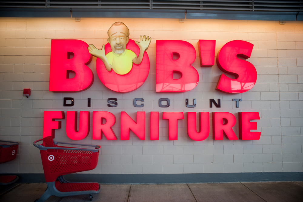 A Bob's Discount Furniture store sign on a wall