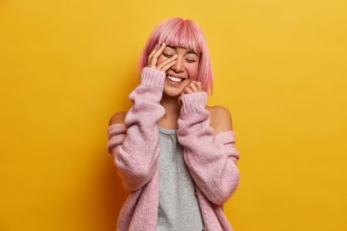 girl with pink hair laughing at funny puns