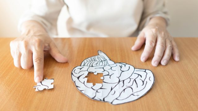 Elderly,Woman,Hands,Putting,Missing,White,Jigsaw,Puzzle,Piece,Down