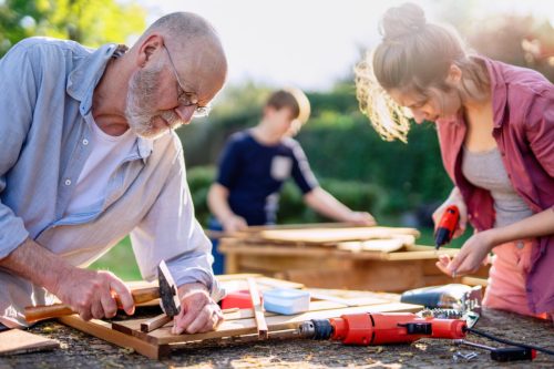 father and daughter participating in a woodworking class for father's day