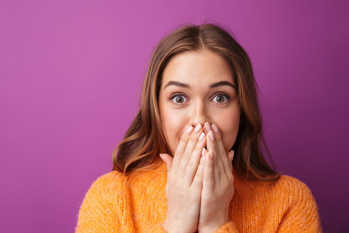 woman covering her mouth trying not to laugh