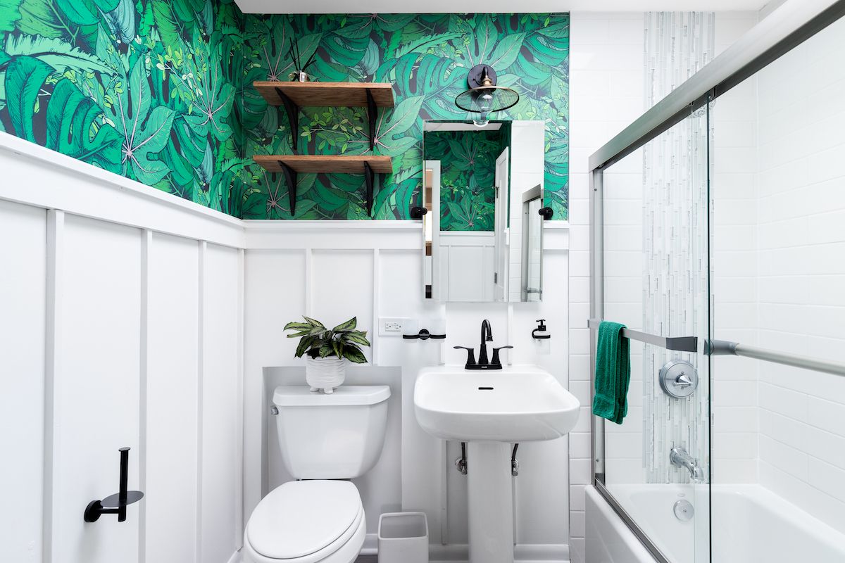 https://bestlifeonline.com/wp-content/uploads/sites/3/2023/04/green-leaf-wallpaper-bathroom.jpg?quality=82&strip=all