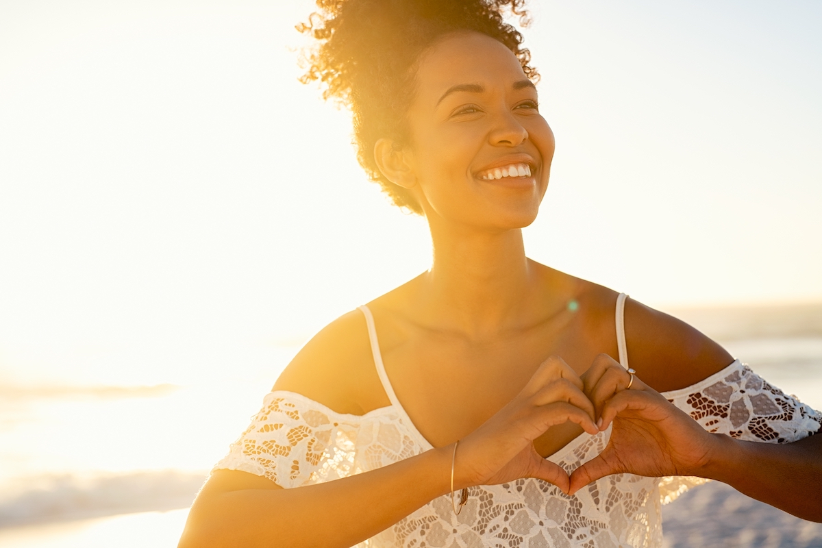woman smiling alone in sunset