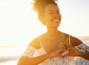 woman smiling alone in sunset