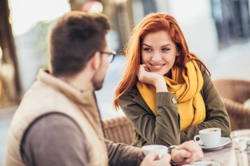 woman sitting on a bench looking at her date
