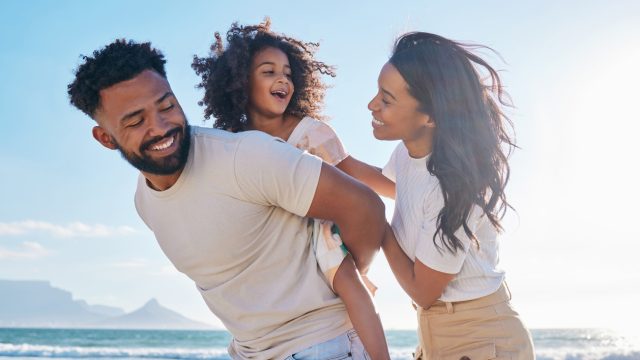 young black family parents and child laughing together