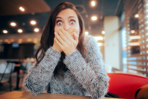 woman surprised covering mouth