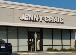 Jenny Craig weight loss clinic building exterior and parking lot in a Houston, TX shopping center.