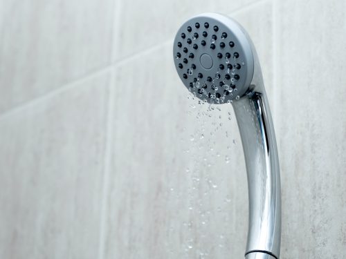 Shower head with low water stream. Broken shower in the bashroom