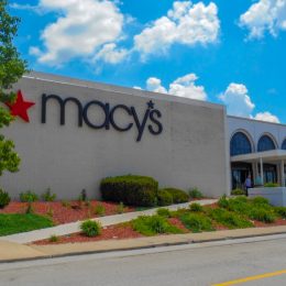 landscaping near entrance to retailer with corporate sign with star logo hanging on outside wall. Cincinnati based Macy’s department stores operates over 660 locations in the United States and is a common anchor tenant at many suburban malls.