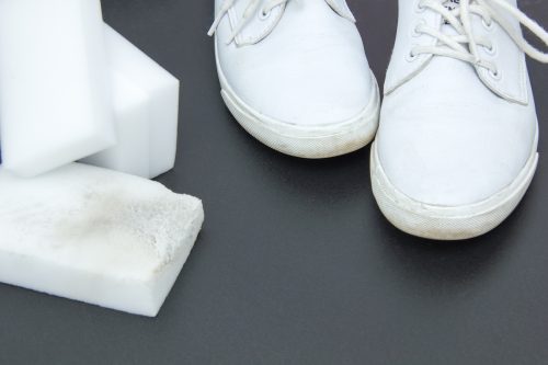 magic erasers and white sneakers on a black background