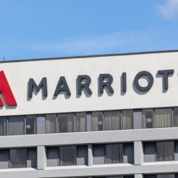 A sign and logo on a Marriott Hotel building