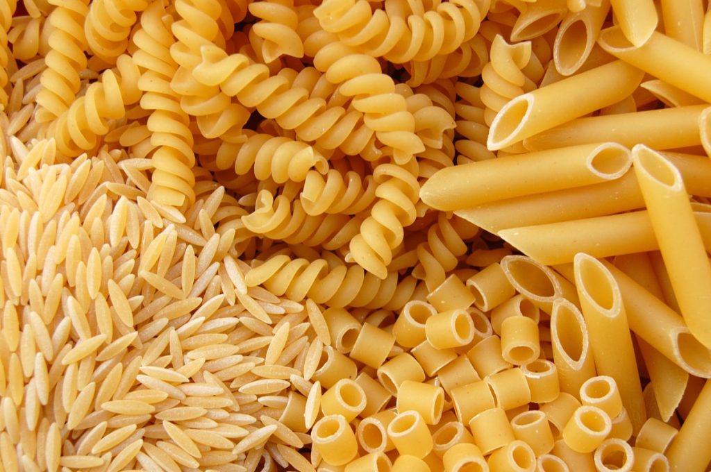 Four different kinds of pasta. Italian food background.