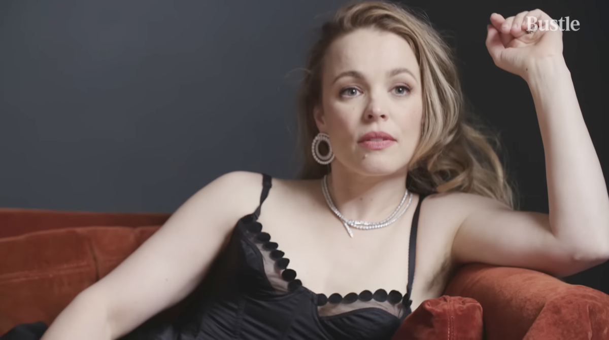 screenshot of rachel mcadams posing on a couch in bustle video