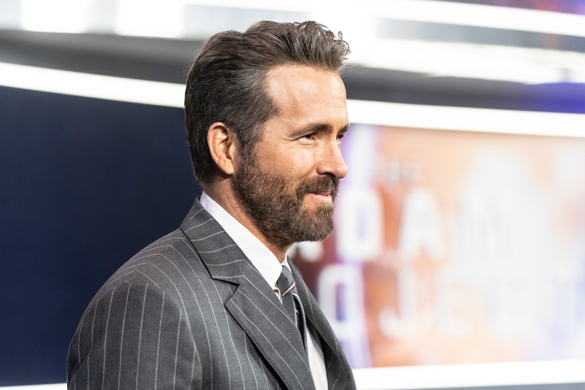 Side view of Ryan Reynolds in a gray pinstripe suit