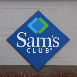 A closeup of a Sam's Club sign on a storefront
