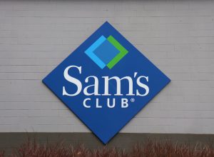 A closeup of a Sam's Club sign on a storefront
