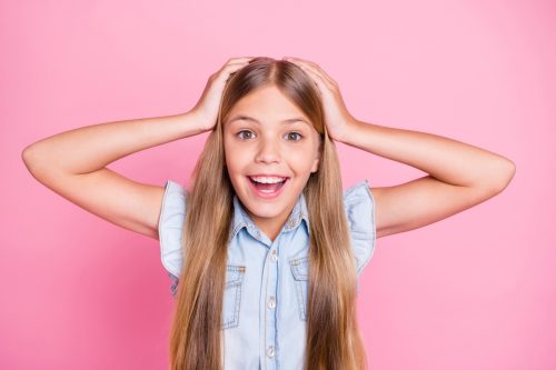 young girl scratching her head as she learns answers to science trivia questions