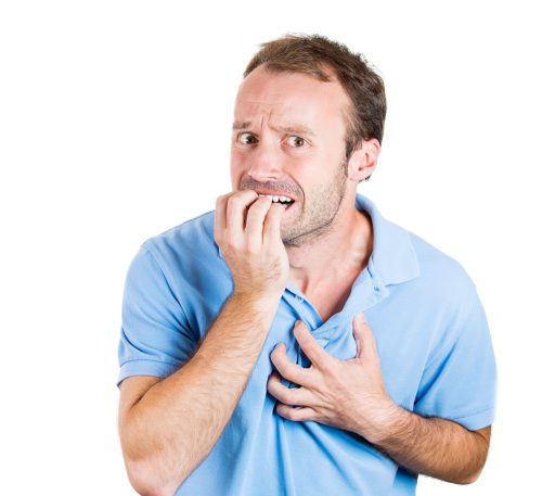 man biting his nails and clutching his chest as he learns answers to weird science trivia questions