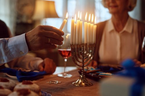 Close up of lighting menorah candles