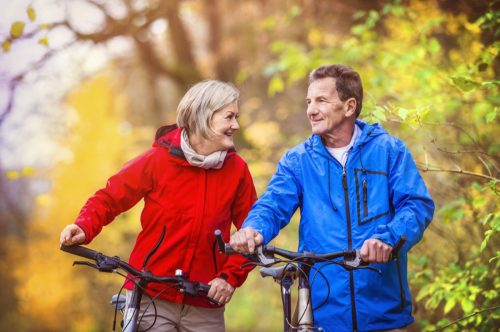 older couple on bikes sharing positive affirmations