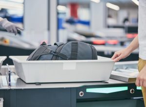 traveler putting bag through airport security