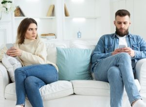 Couple on couch with cell phones