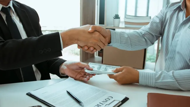 Business deal with cash and contract