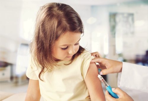 little girl receiving a flu vaccine