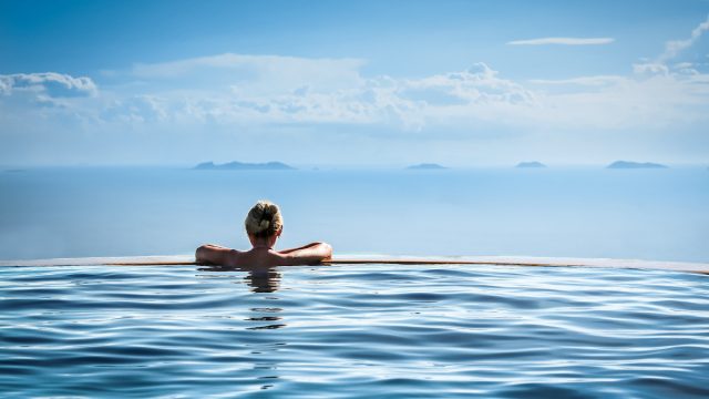 woman infinity pool luxury hotel