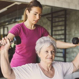 Senior woman lifting weights to keep bones healthy and prevent dementia