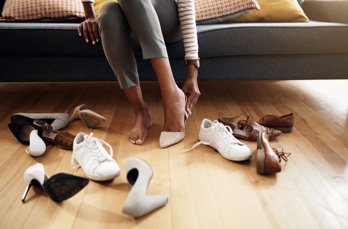 Cropped shot of an unrecognizable woman trying on various shoes at home