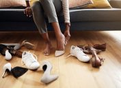 Cropped shot of an unrecognizable woman trying on various shoes at home