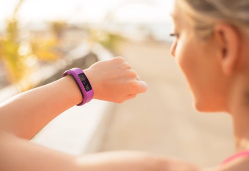 Woman checking fitness and health tracking wearable device