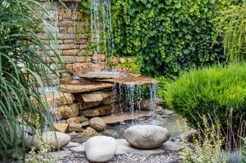 A small decorative waterfall in the garden. Landscape design feng shui