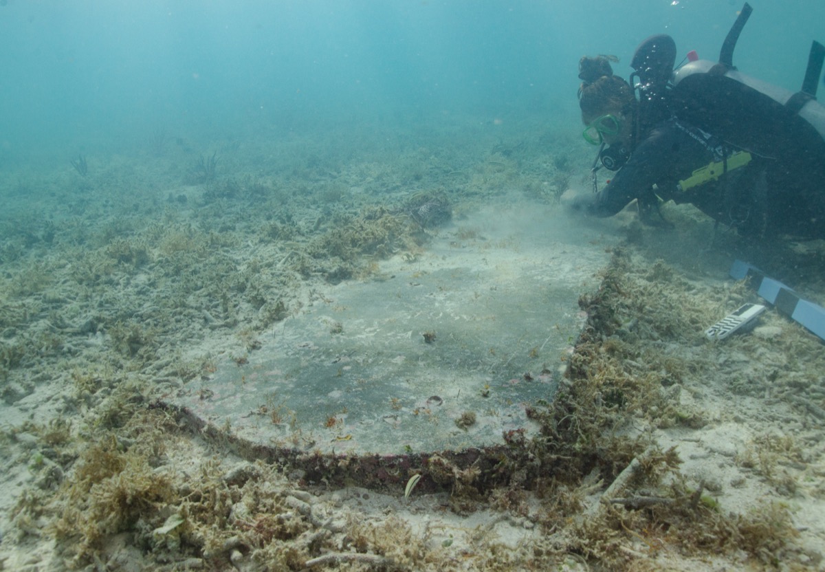 diver examining underwater headstone at dry tortugas national park