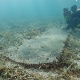 diver examining underwater headstone at dry tortugas national park