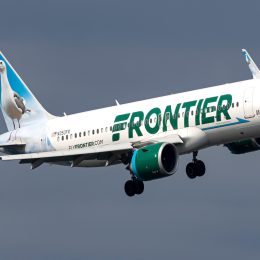 Frontier airplane flying in the sky to destination.