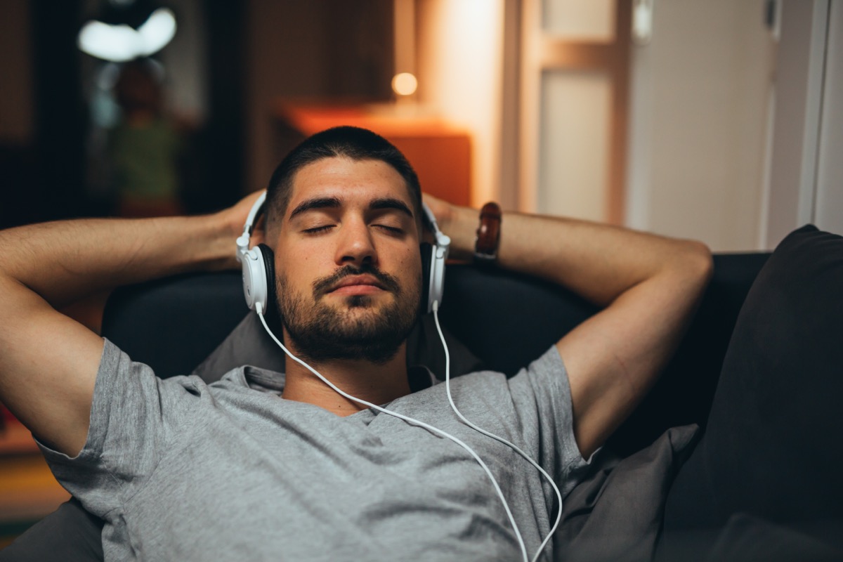 Man Laying Back with Headphones On