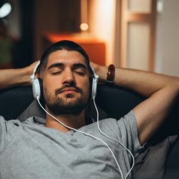 Man Laying Back with Headphones On