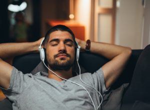 Man Laying Back with Headphones On